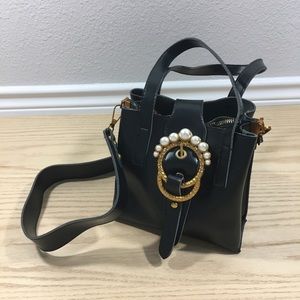 Black handbag with gold pearl buckle purse